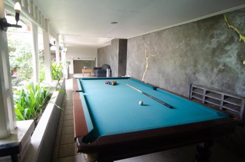 a pool table in the middle of a room at Country Heritage Hotel in Surabaya