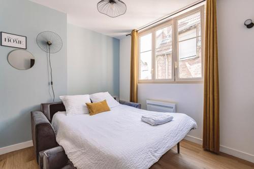 a small bedroom with a bed and a window at Reims - City Center - Cathédrale - FORUM in Reims