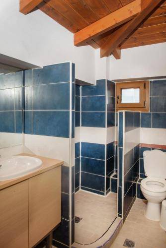 a bathroom with a toilet and a sink at 3D iliadis Suites in Ierissos