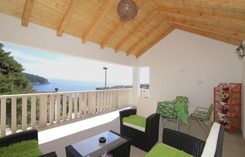 a living room with a balcony with a view of the ocean at Rooms&Studios Rina in Dubrovnik