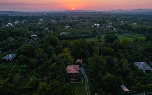 an aerial view of a house in a forest at sunset at Menabde Winery in Ozurgetʼi