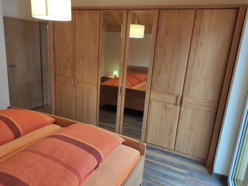 a bedroom with two beds and a mirror at Ferienwohnungen Graßmann in Piding