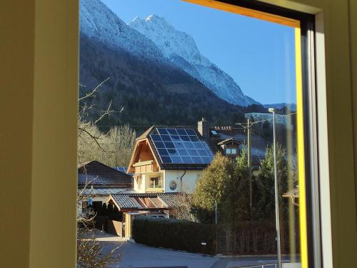a view from a window of a village with a mountain at Ferienwohnungen Graßmann in Piding