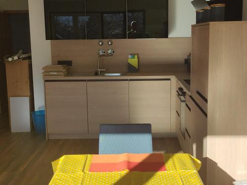 a model of a kitchen with a table and a chair at Ferienwohnungen Graßmann in Piding