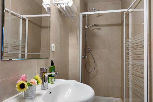 a bathroom with a sink and a shower at Aparthotel AMMI Nice Massena - ex Ajoupa in Nice
