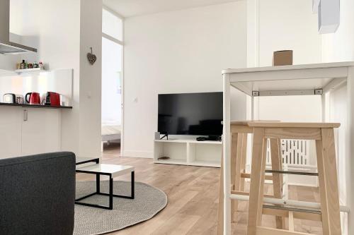 a white living room with a couch and a table at 100 Grenoble #BT in Grenoble