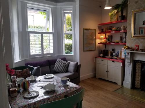 a living room with a table and a couch at Acara House B&B in Dublin