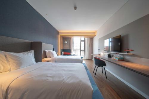 Postel nebo postele na pokoji v ubytování Holiday Inn Express Yixing by IHG