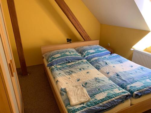 a bed with two pillows on it in a room at Ubytování Chotěvice in Hostinné