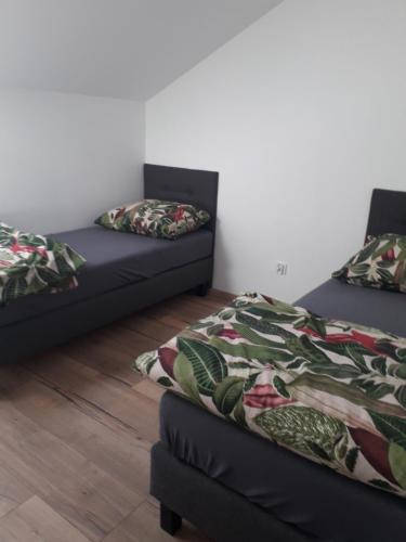 a room with two twin beds and a couch at Apartament Nad Jeziorem Ewa in Nadole
