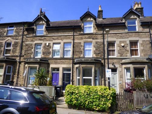 a brick house with a car parked in front of it at 4 Bedroom House in Harrogate Town Centre in Harrogate