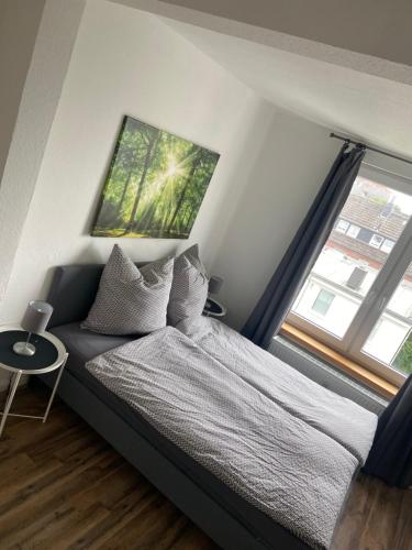 a bedroom with a bed and a large window at Ferienwohnung Robbe in Wilhelmshaven