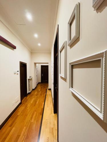 a hallway of a home with white walls and wooden floors at L’Arco Bed&Breakfast in Avigliano