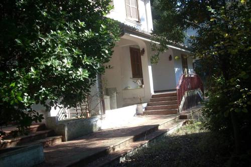 Appignano的住宿－Appartamento in villa，白色的房子,有楼梯通往门