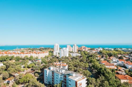 an aerial view of a city with tall buildings and the ocean at Seguros House - Charming Flat in Cascais