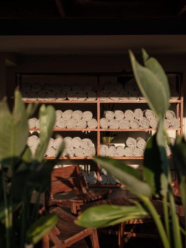 a shelf filled with plates and vases at OKU Ibiza in San Antonio