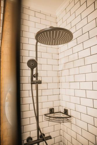 a shower with two shelves in a bathroom at Seguros House - Charming Flat in Cascais