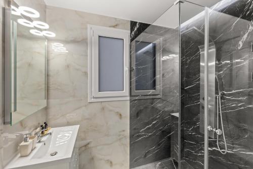 a bathroom with a shower and a sink and a mirror at Athens Warehouse Boutique Hotel & Suites in Athens