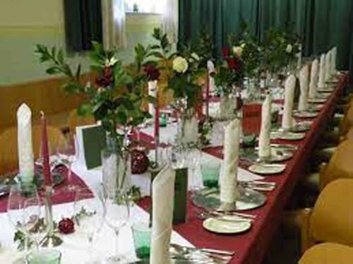 a long table with glasses and flowers on it at Gasthof Hofbauer in Jagenbach