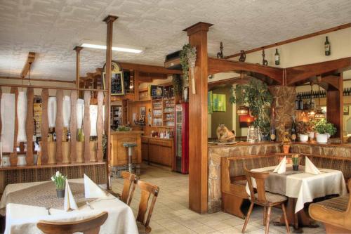 ein Restaurant mit Tischen und Stühlen und eine Bar in der Unterkunft Gasthof Hofbauer in Jagenbach