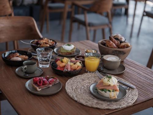 a table topped with plates of breakfast foods and drinks at OKU Ibiza in San Antonio