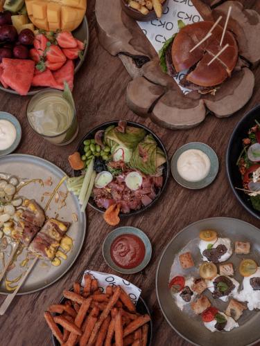 a wooden table with plates of food on it at OKU Ibiza in San Antonio