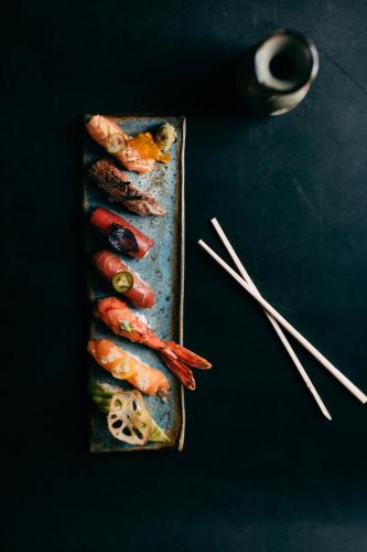 a plate of food with shrimp on a table with chopsticks at OKU Ibiza in San Antonio