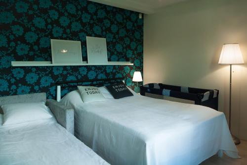 - une chambre avec 2 lits et un mur recouvert de papier peint dans l'établissement Hermann View Apartment, à Tallinn