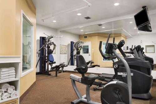 a gym with two tread machines and a mirror at Days Inn by Wyndham Saskatoon in Saskatoon
