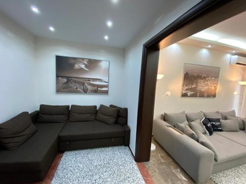 a living room with a sectional couch at Ioannina Luxury Suites & Apartments in Ioannina