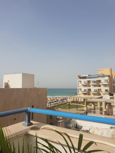 a view of the beach from the balcony of a building at Pearl island suite in Ashkelon