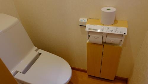 a bathroom with a toilet and a roll of toilet paper at Villa Ensoleille in Fujikawaguchiko