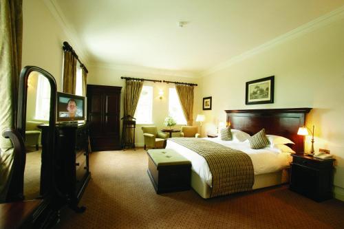 a hotel room with a bed and a television at Mount Falcon Estate in Ballina