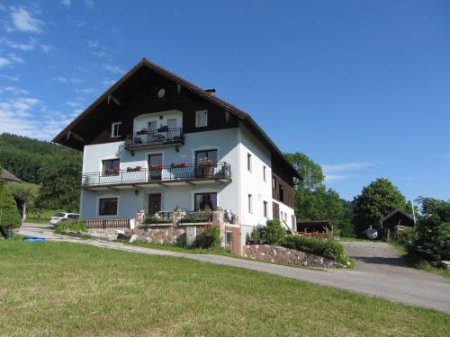 a large white house with a black roof at Bauernhof Schink in Zell am Moos