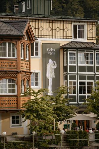 a building with a statue in front of it at Hotel Goldener Ochs in Bad Ischl