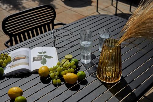 a table with fruit and a book and a vase at Schwan Locke in Munich