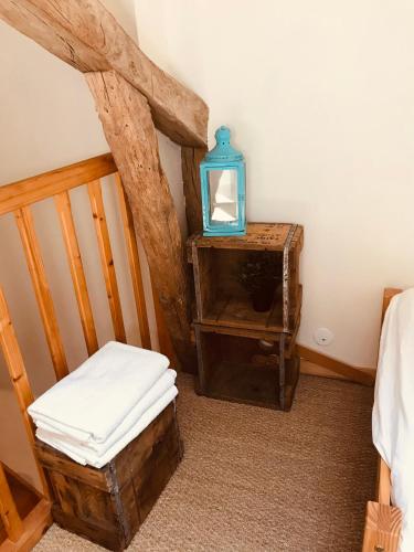 a room with a chair and a table with a mirror at La Belle Verte in Grignols Dordogne