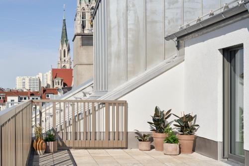 a balcony with plants on the side of a building at Schwan Locke in Munich
