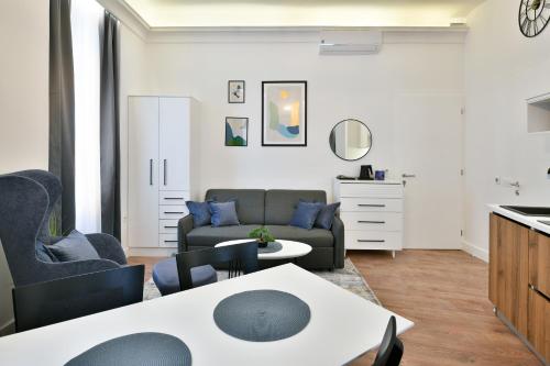 a living room with a couch and a table at Luxury Galla Apartments in the City Center in Sarajevo