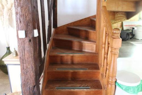 a wooden staircase with wooden steps in a house at La Chaumière in Saint-Martin-Saint-Firmin