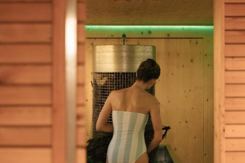 a woman in a white dress standing in a room at Hotel Goldener Ochs in Bad Ischl