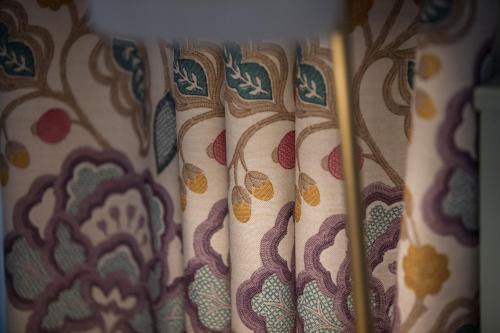 a close up of a curtain with patterns on it at Hotel Goldener Ochs in Bad Ischl
