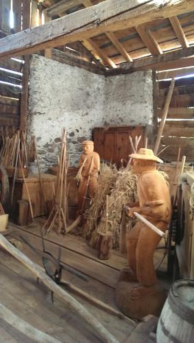 two statues of men in a barn with hay at Hotel Crusch Alba Sta Maria in Sta Maria Val Müstair