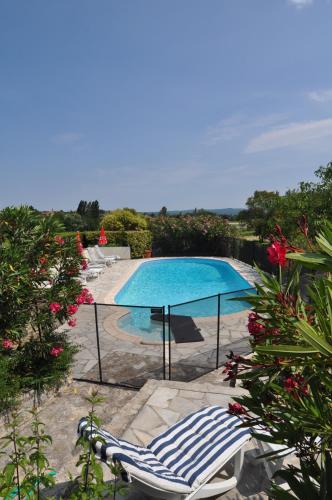 une piscine avec deux chaises longues à côté dans l'établissement Domaine le Bourdet, à Saint-Sauveur-de-Cruzières