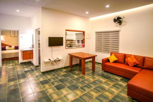 a living room with a couch and a table at Willow House Vagamon in Vagamon