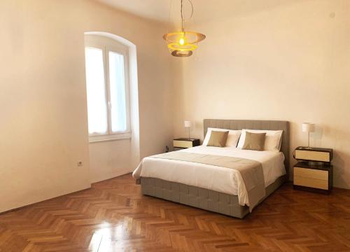 a bedroom with a large bed and a window at Apartment Porto Poreč in Poreč
