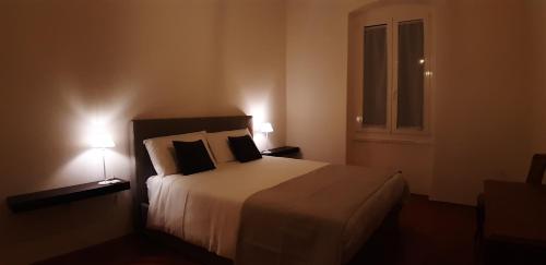 a bedroom with a large bed with two lamps at Apartment Porto Poreč in Poreč