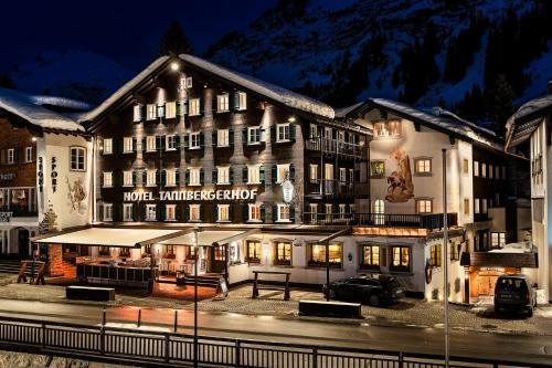 a hotel in front of a mountain at night at Hotel Tannbergerhof im Zentrum von Lech in Lech am Arlberg