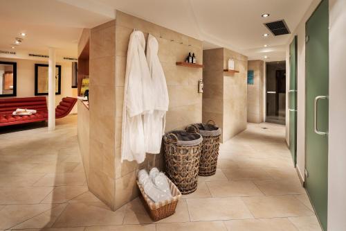 a bathroom with a shower and two trash cans at Hotel Tannbergerhof im Zentrum von Lech in Lech am Arlberg