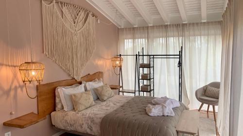 PicoTerrace في مادالينا: غرفة نوم بسرير مع مصباحين وكرسي